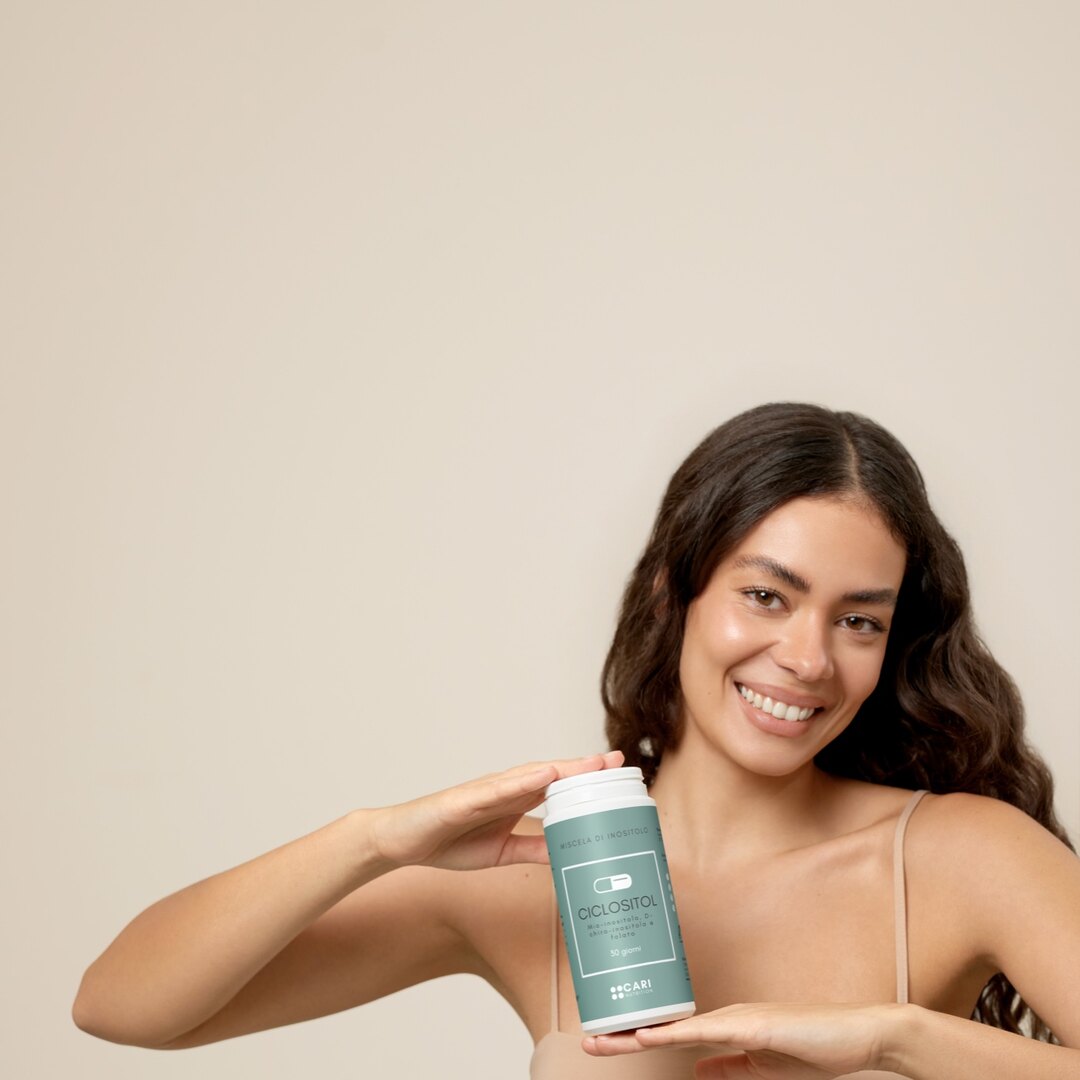 Donna che presenta il barattolo di Ciclositol in capsule di CARI Nutrition